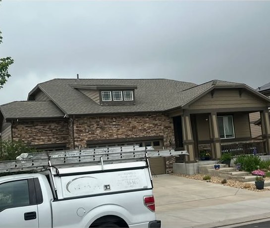 Craftsman-style home exterior with JMG work truck on site