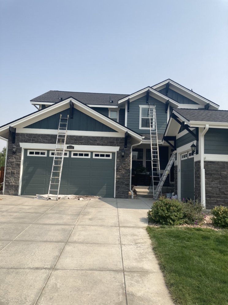 Two-story craftsman repainted blue-gray with white trim
