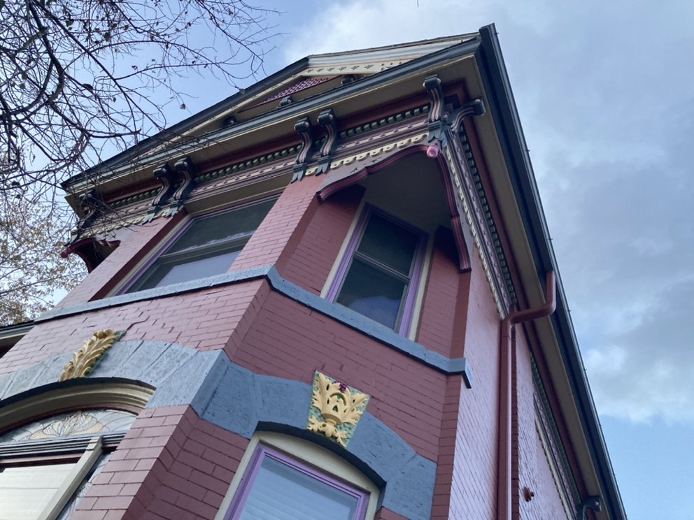 Historic brick building with multi-color painted trim